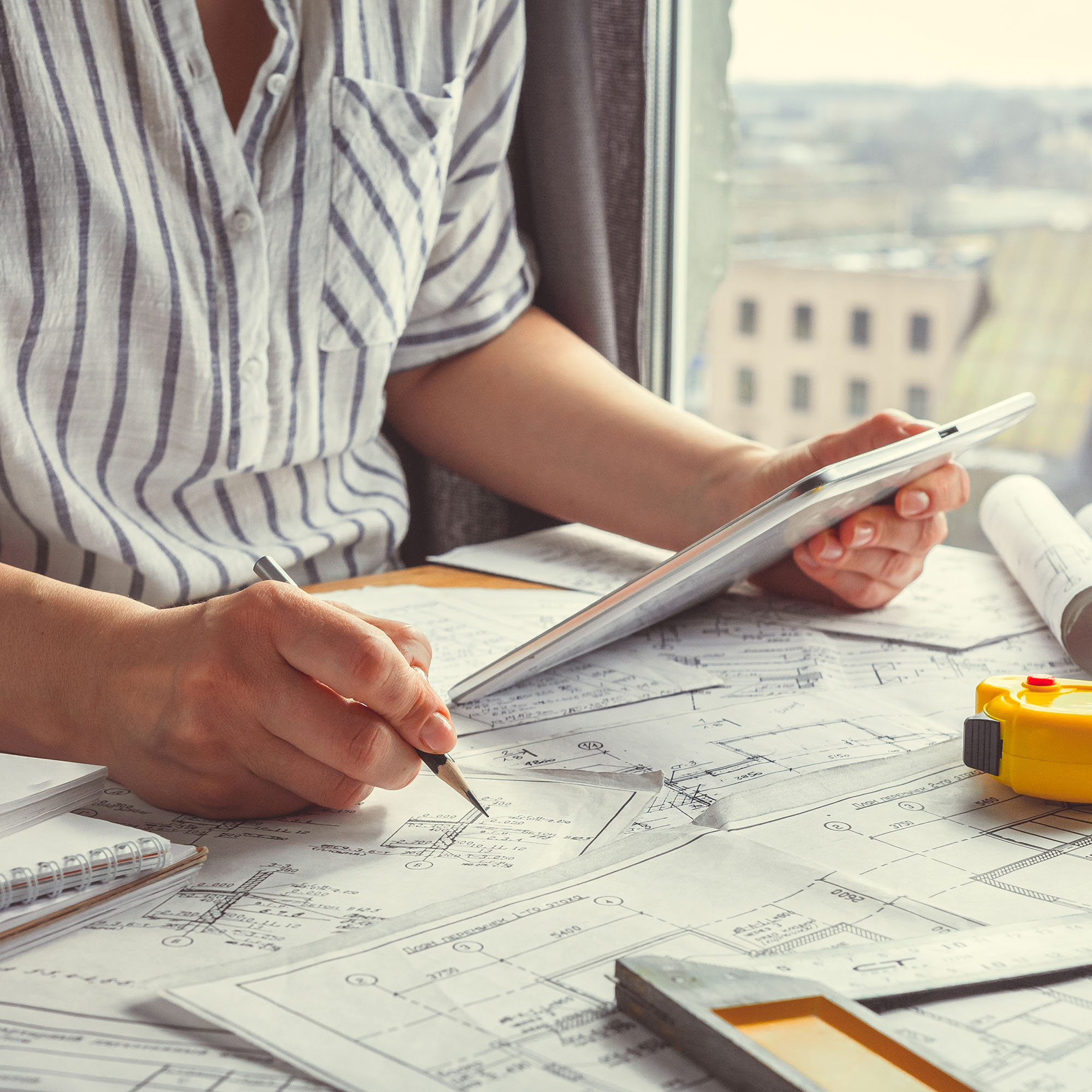 Architect works remotely from home in quarantine, lockdown covid 19 coronavirus. Remote work, stay home, new normality, social distance. Architect design working drawing sketch plans blueprints